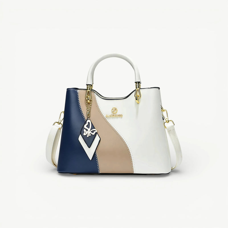 Internal compartments and gold-tone zipper detail of Aria handbag