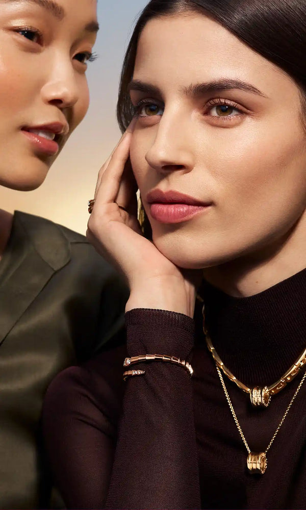 Woman wearing gold layered necklace and pearl earrings – EastCurated